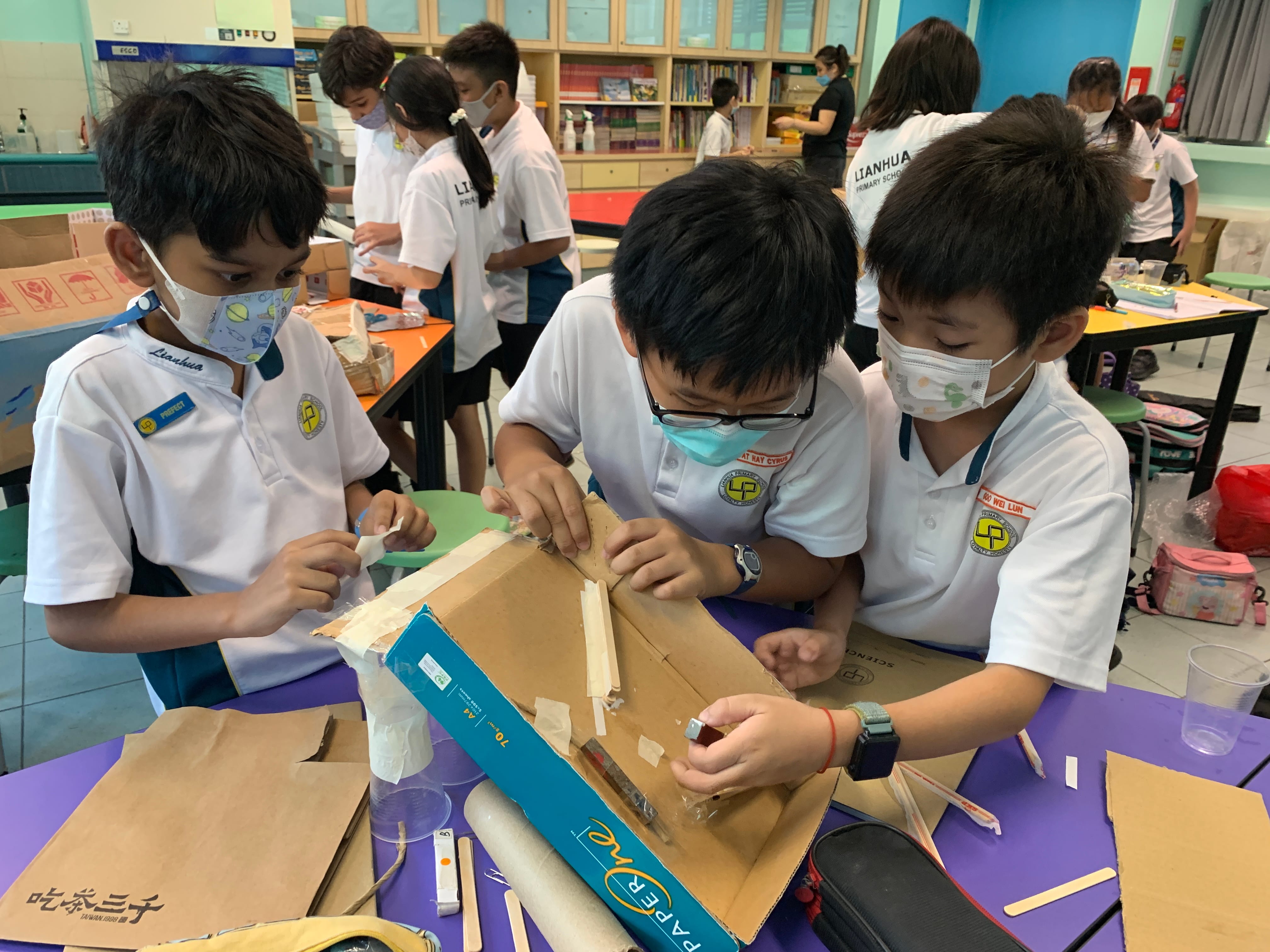 Three boys making of prototypes to separate waste